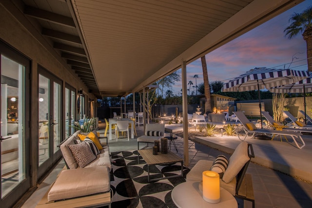 patio terrace at dusk featuring an outdoor hangout area