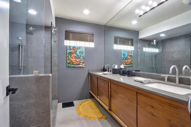 bathroom featuring vanity and tiled shower