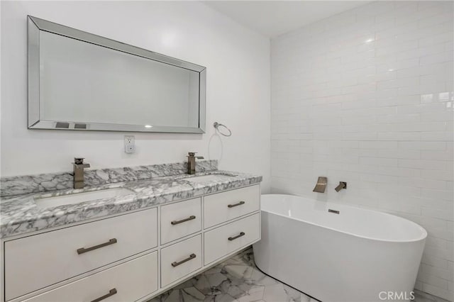 bathroom with a tub to relax in and vanity