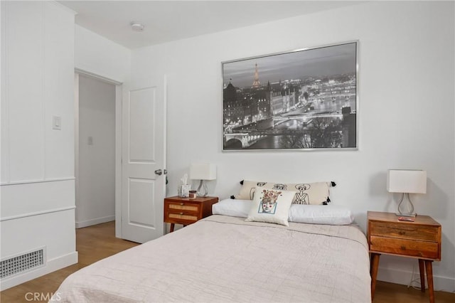 bedroom with hardwood / wood-style flooring