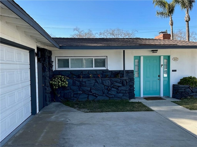 doorway to property with a garage