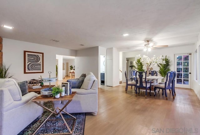 living room featuring ceiling fan and light hardwood / wood-style flooring