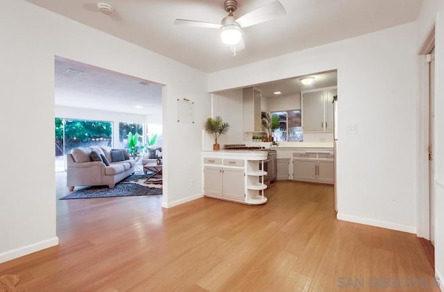 kitchen with white cabinetry, plenty of natural light, ceiling fan, and light hardwood / wood-style floors