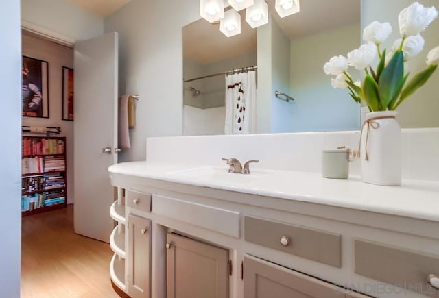 bathroom featuring hardwood / wood-style floors, vanity, a shower with shower curtain, and toilet