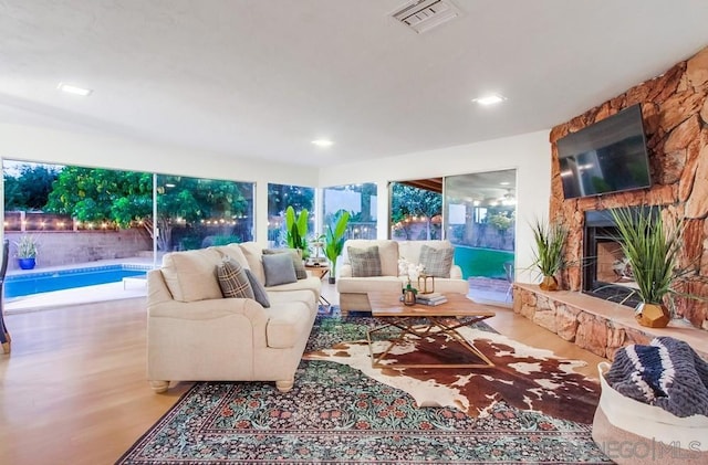 living room with light hardwood / wood-style floors and a fireplace