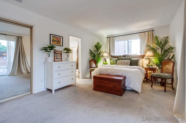 carpeted bedroom with multiple windows and access to exterior