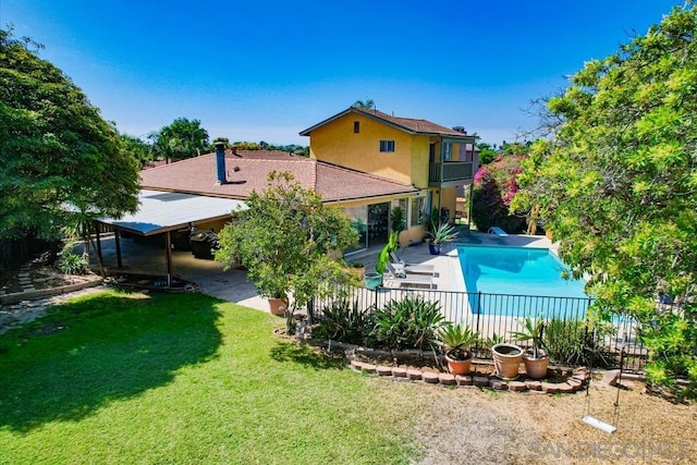 view of swimming pool featuring a patio area and a yard