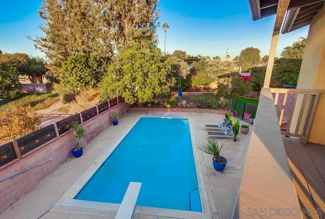 view of pool featuring a diving board