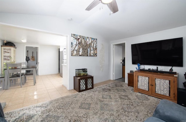 living room featuring light tile patterned floors, ceiling fan, and lofted ceiling