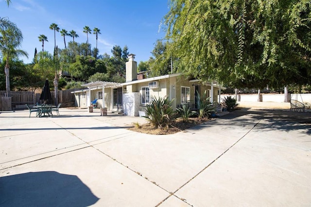 view of front facade with a pergola and a patio area