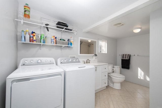 washroom featuring washer and dryer, light tile patterned floors, and sink