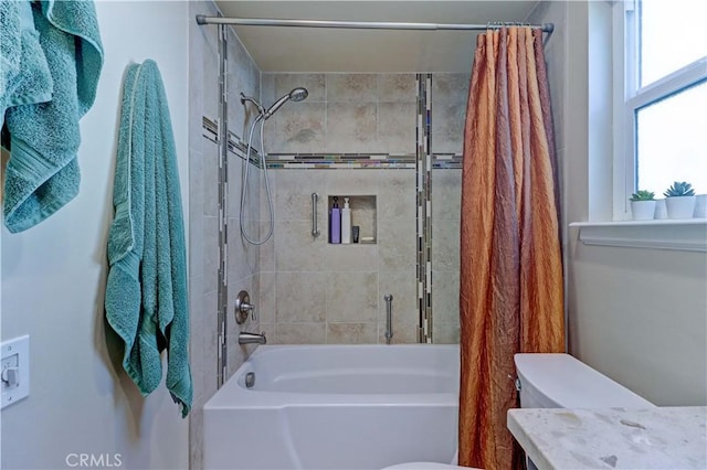 bathroom with toilet and shower / bath combo