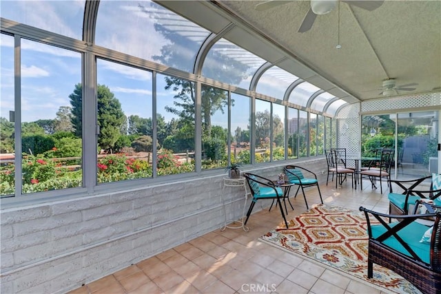 unfurnished sunroom featuring ceiling fan