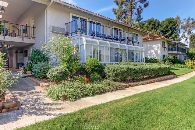 exterior space with a yard and a balcony