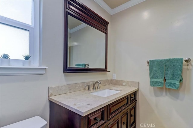 bathroom featuring ornamental molding, vanity, and toilet