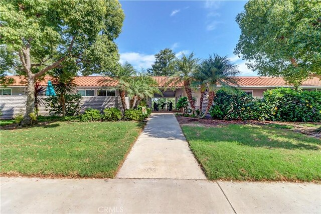 mediterranean / spanish home with a front yard