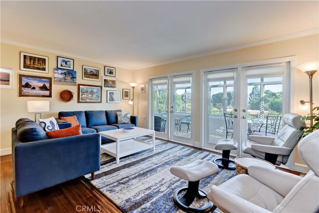 living room with a healthy amount of sunlight, dark hardwood / wood-style flooring, and french doors