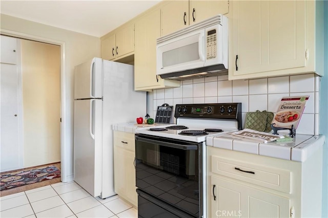 191 Kennebec Ave Unit 301, Long Beach, CA 90803 - kitchen featuring white appliances, tile countertops, decorative backsplash, and light tile patterned floors