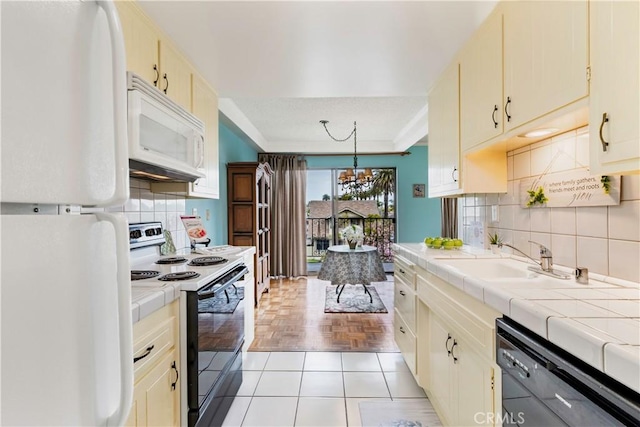 191 Kennebec Ave Unit 301, Long Beach, CA 90803 - kitchen with white appliances, tile counters, a chandelier, a sink, and decorative backsplash