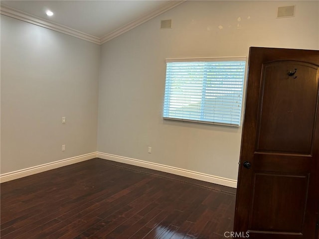 unfurnished room with dark hardwood / wood-style flooring, vaulted ceiling, and ornamental molding