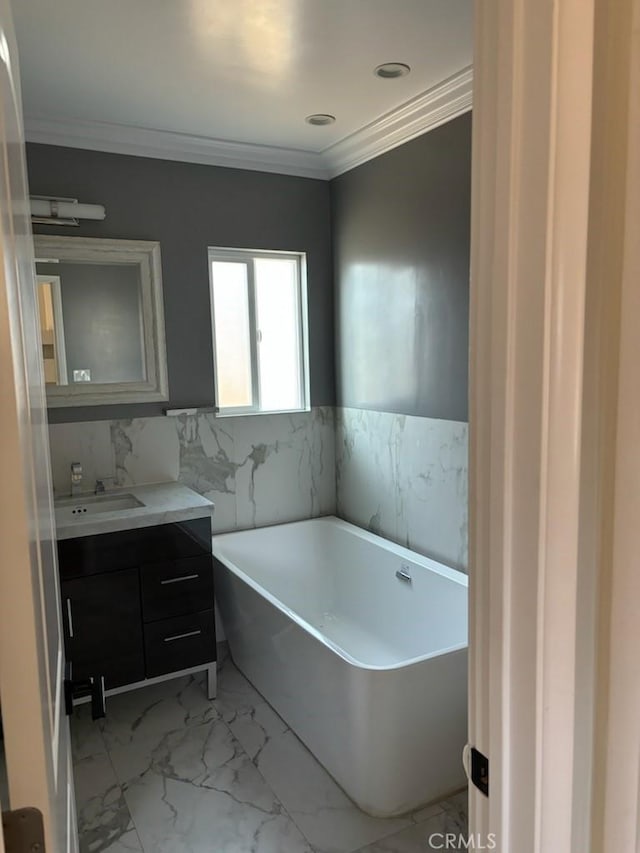 bathroom featuring vanity, a bath, and ornamental molding