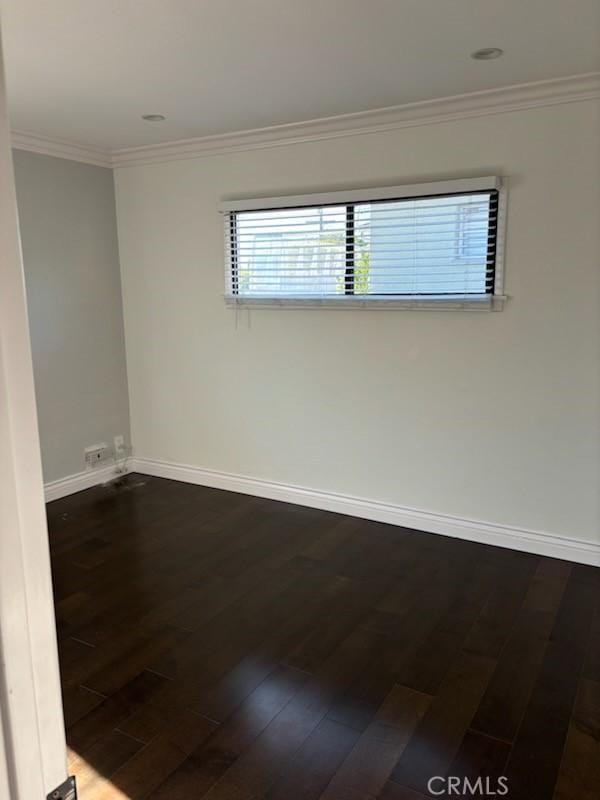 spare room with crown molding and hardwood / wood-style floors