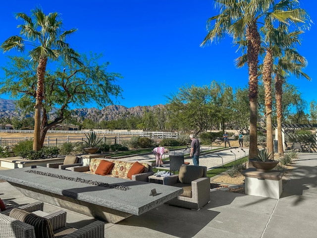 view of community featuring a patio area and a mountain view