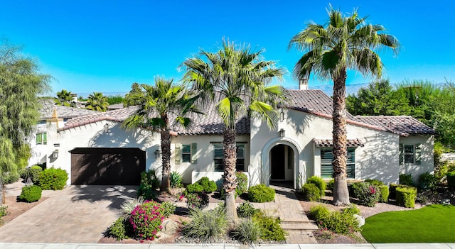 mediterranean / spanish home with a garage