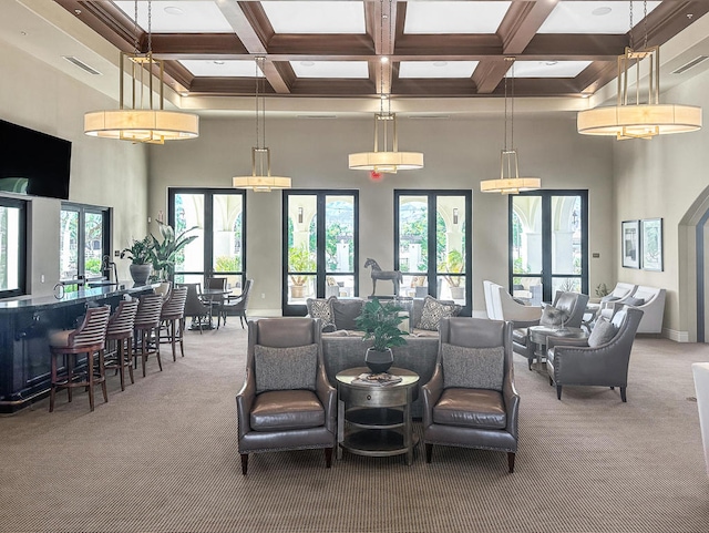 living room featuring a towering ceiling, carpet flooring, beamed ceiling, and coffered ceiling