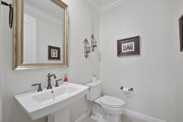 bathroom featuring ornamental molding, sink, and toilet