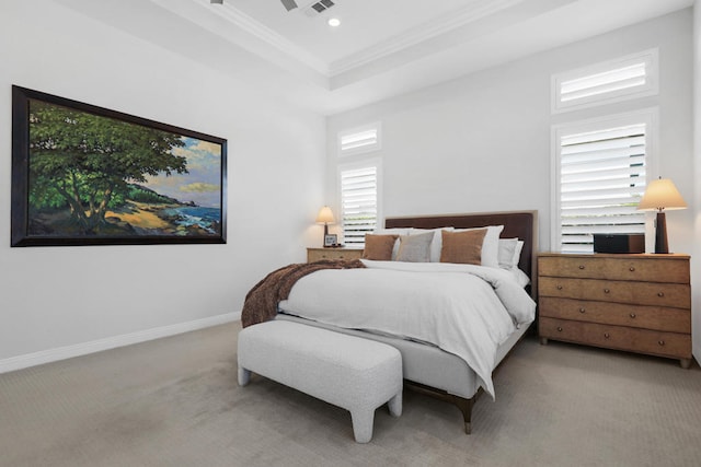 bedroom featuring multiple windows, ornamental molding, light colored carpet, and a raised ceiling