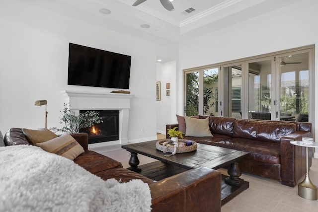 living room featuring a towering ceiling, ornamental molding, and ceiling fan