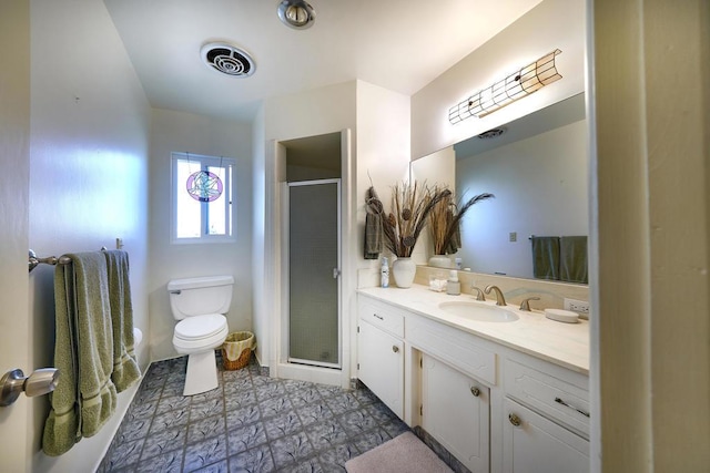 bathroom with toilet, vanity, and walk in shower