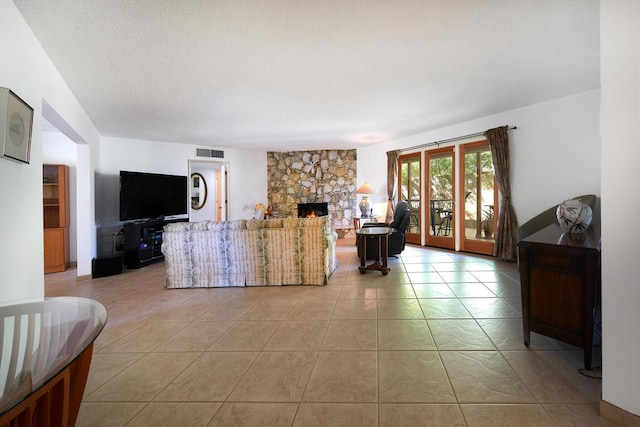 living room with light tile patterned floors and a fireplace