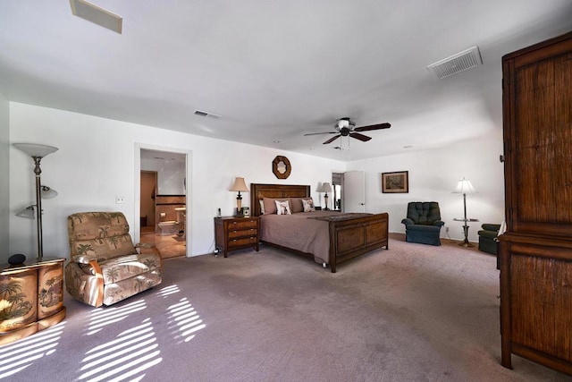 bedroom with carpet floors, ceiling fan, and connected bathroom