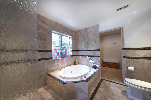 bathroom featuring toilet, tile walls, and tiled tub