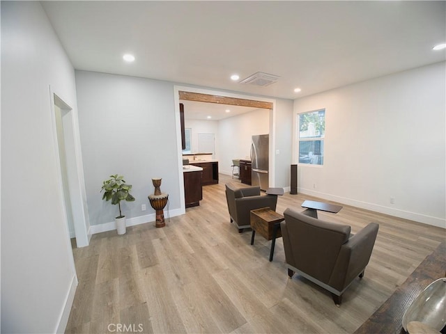 interior space with baseboards, light wood-type flooring, and recessed lighting