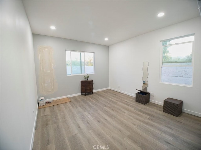 spare room with recessed lighting, light wood-style flooring, and baseboards