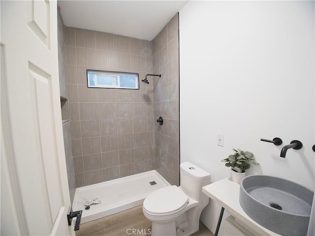 full bath featuring toilet, a shower stall, wood finished floors, and vanity