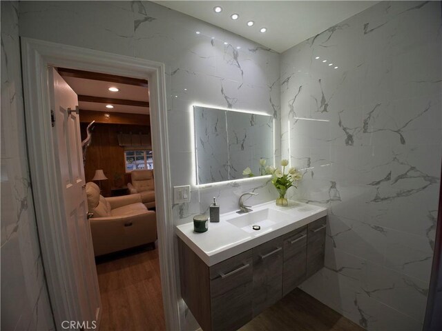 bathroom featuring recessed lighting, vanity, wood finished floors, and ensuite bathroom