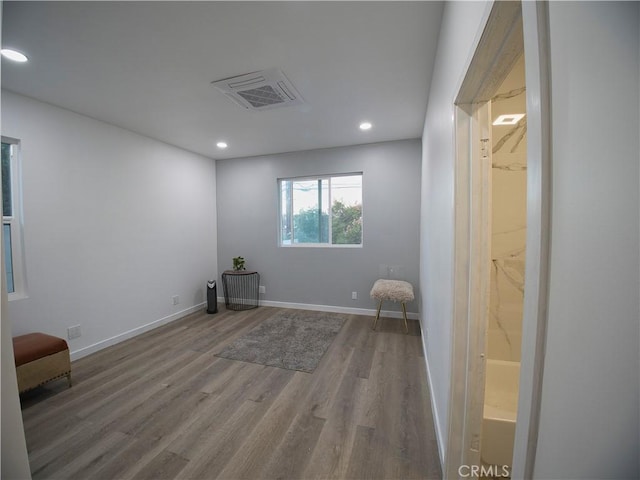 empty room featuring recessed lighting, visible vents, baseboards, and wood finished floors