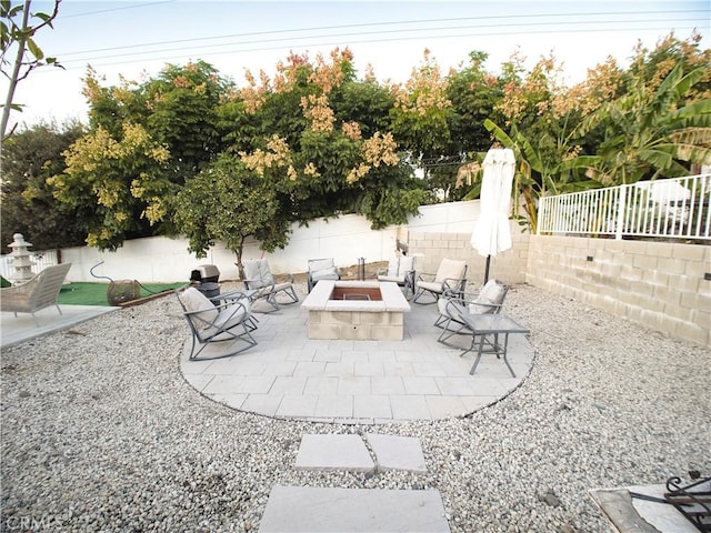 view of patio / terrace with a fire pit and a fenced backyard