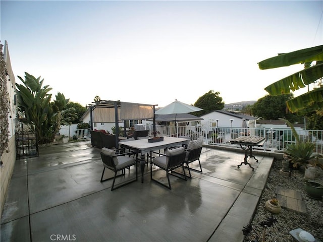 view of patio / terrace featuring outdoor dining area, fence, and a pergola