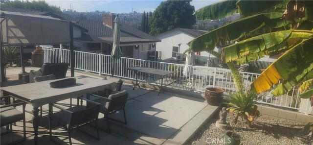 view of patio / terrace featuring fence