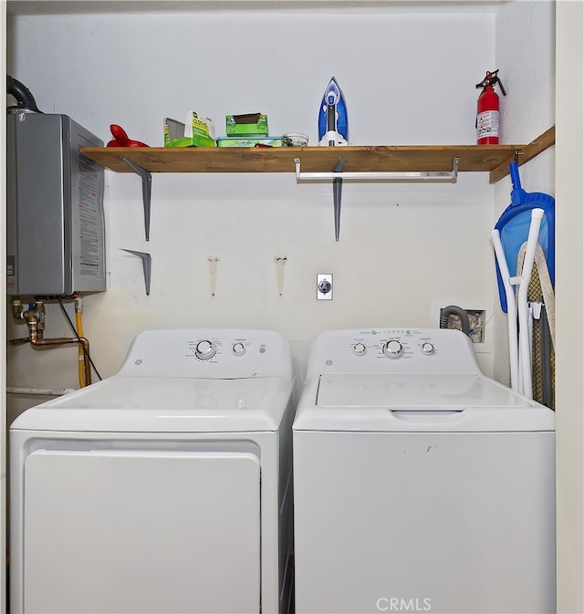 laundry area with tankless water heater and washer and clothes dryer