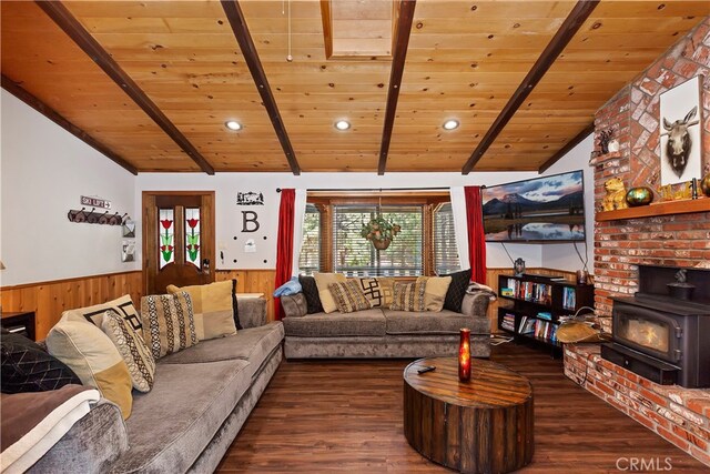 living room with wood ceiling, lofted ceiling with beams, and a wood stove