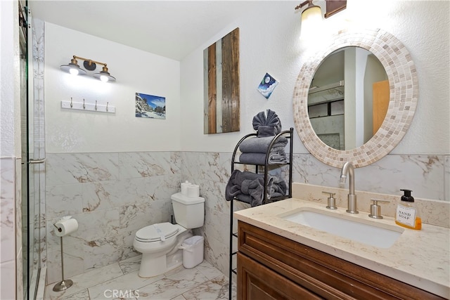 bathroom featuring vanity, tile walls, and toilet