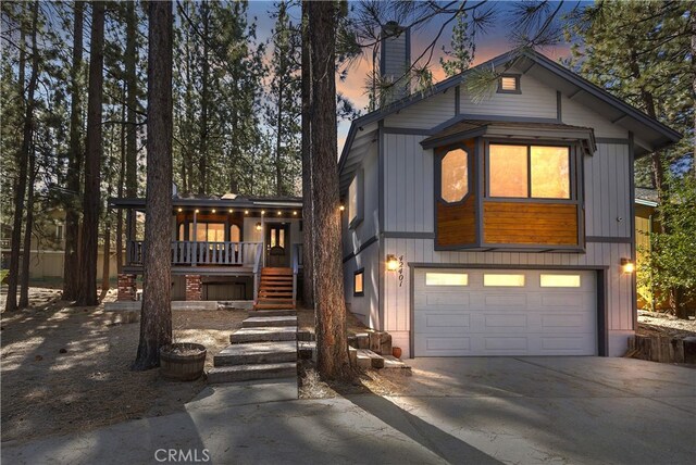 view of front of property with covered porch and a garage