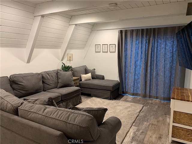 living room with beamed ceiling and wood-type flooring