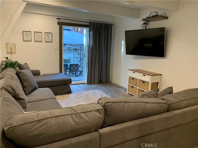 living room with beam ceiling and light hardwood / wood-style floors